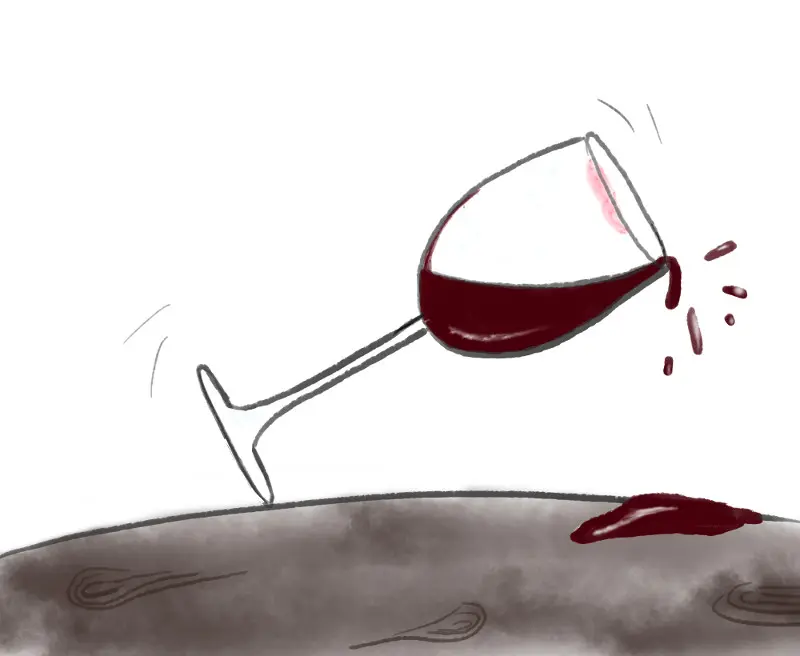 verre de vin prêt à tomber et à se briser